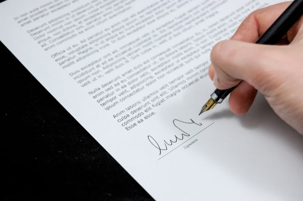 person signing employment contract